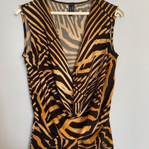 A tiger printed blouse and lower V neckline with a drape style at the front .